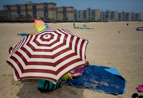 A red and white bullseye beach umbrella at Rockaway Beach in Queens, New York.